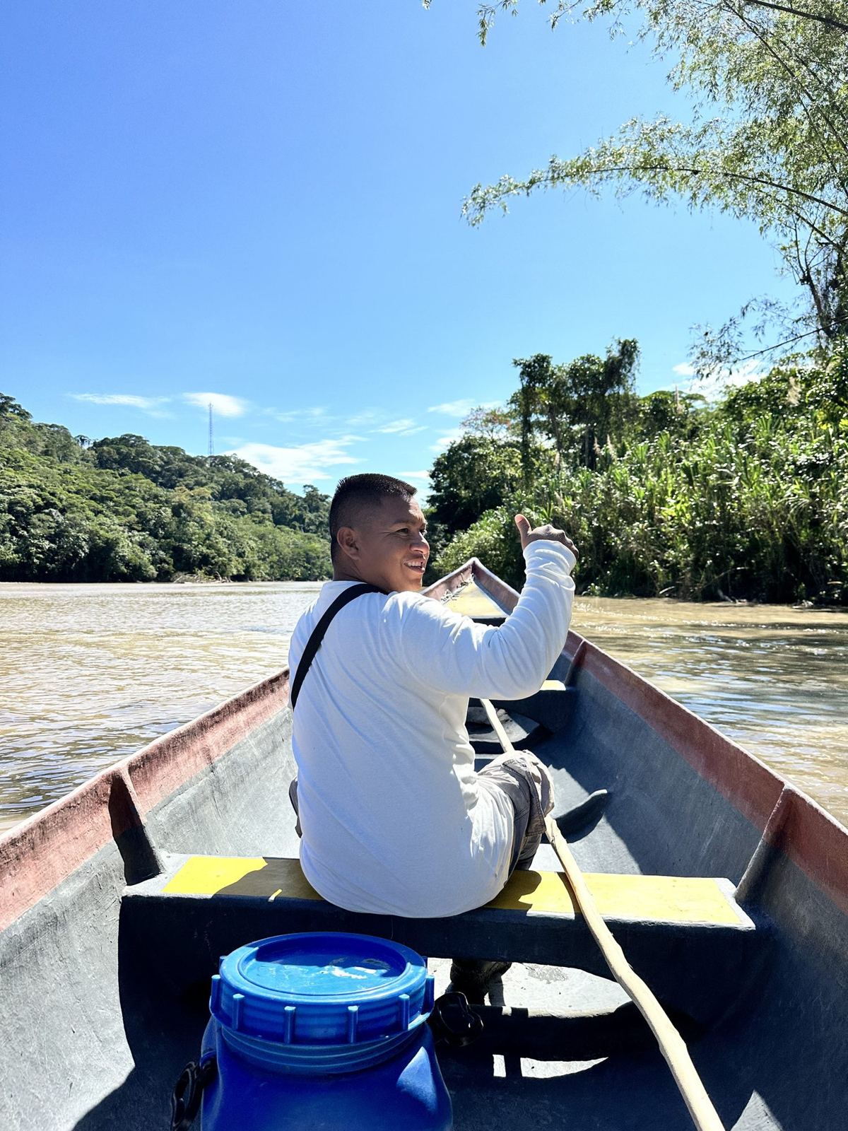 A man steering a canoe on a wide river