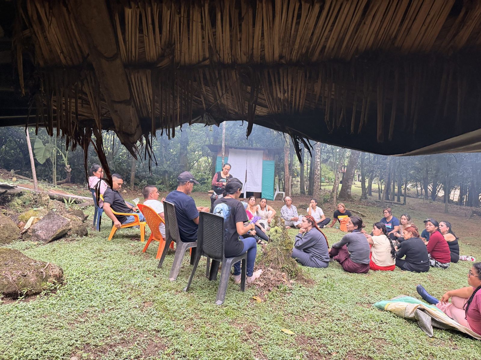 Guests sitting together in a circle on the grass
