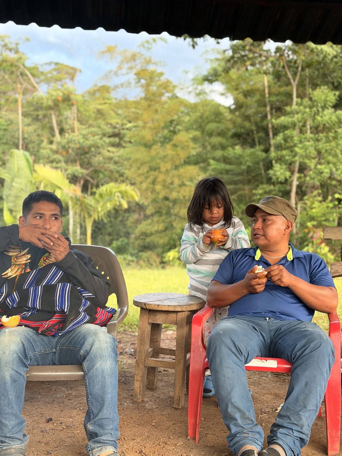 Members of Taita Miguel's family sitting together outside