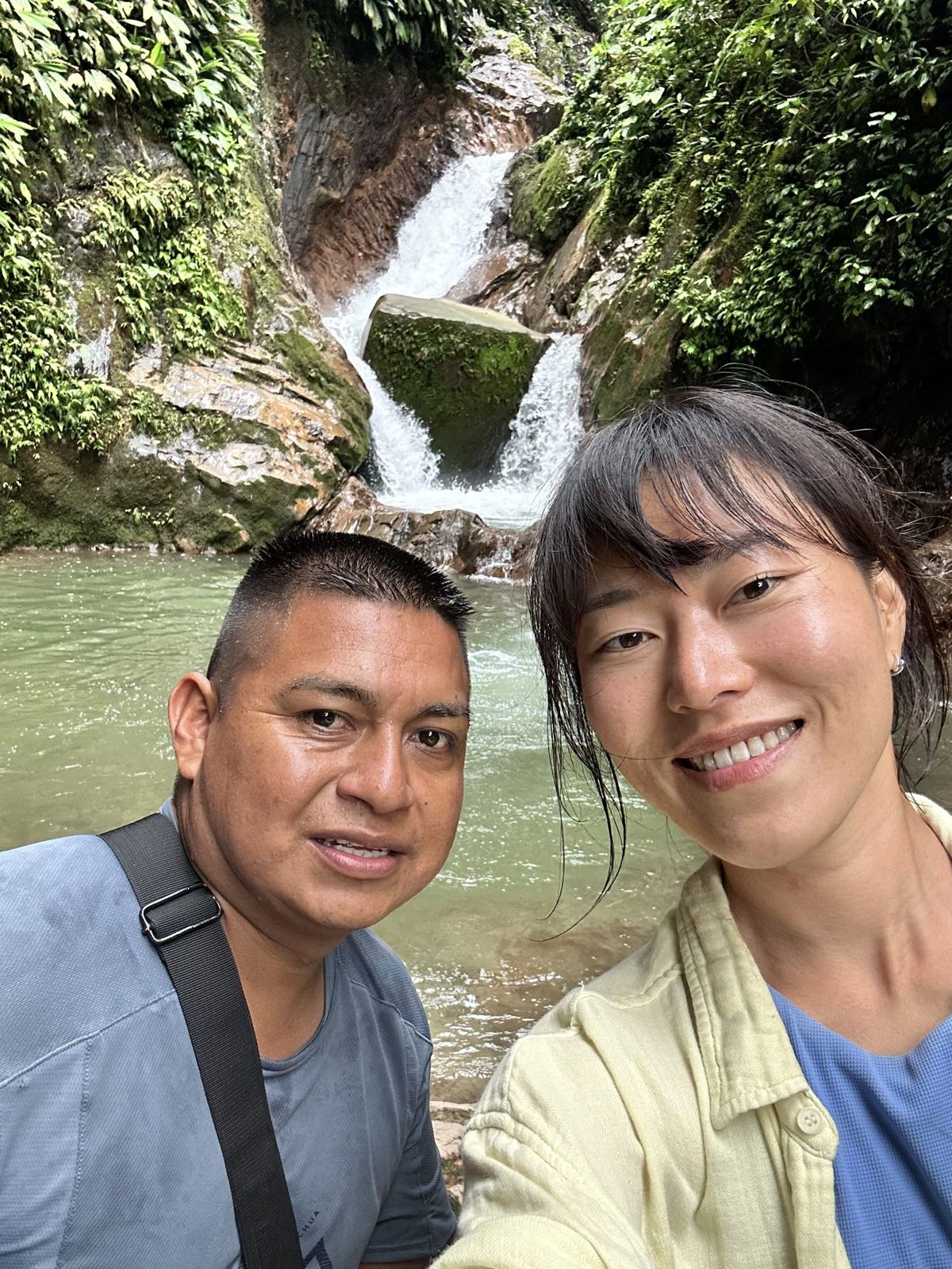 Min smiling in front of a waterfall