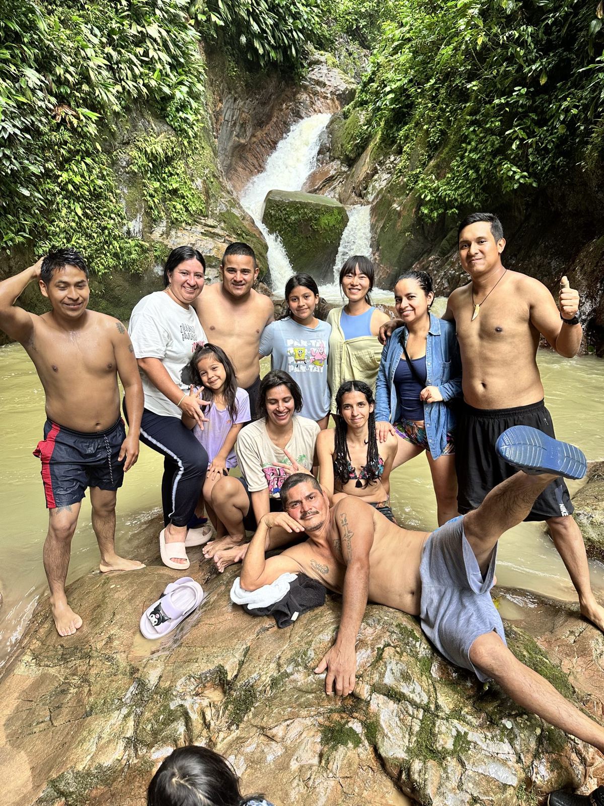Friends at the foot of a waterfall