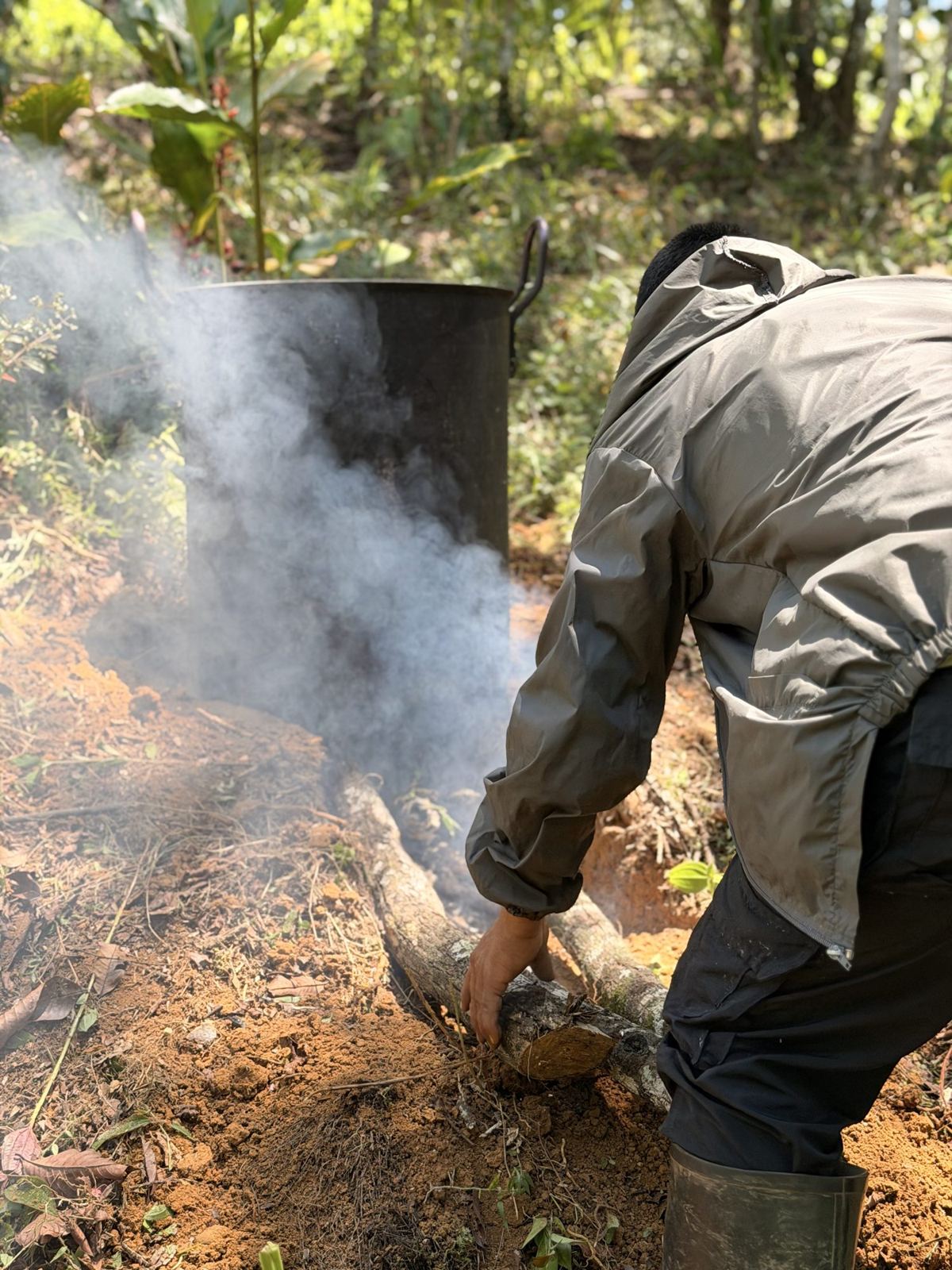 Smoke rising from the fire under the yagé pot